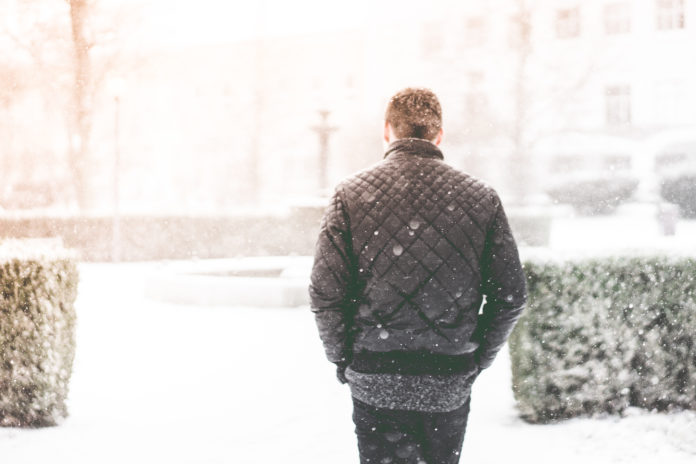 Man Walking in Snowfall Photo by Viktor Hanacek